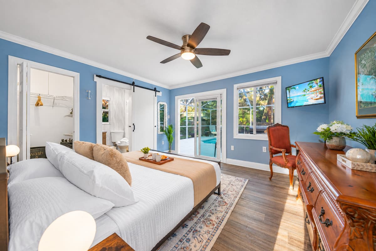 This bright and airy king bedroom offers a serene setting ideal for unwinding and restful sleep.