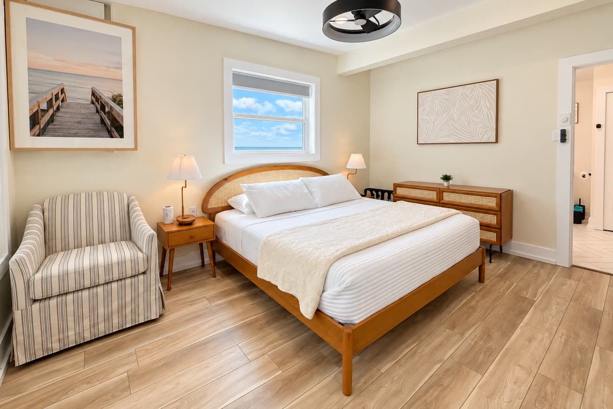 King bedroom with a woven wood headboard and coastal decor.