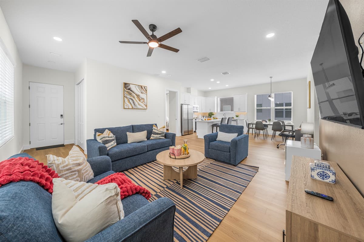 The entire open-concept layout in one view — living room, kitchen, and dining all flowing together for the perfect group hangout.