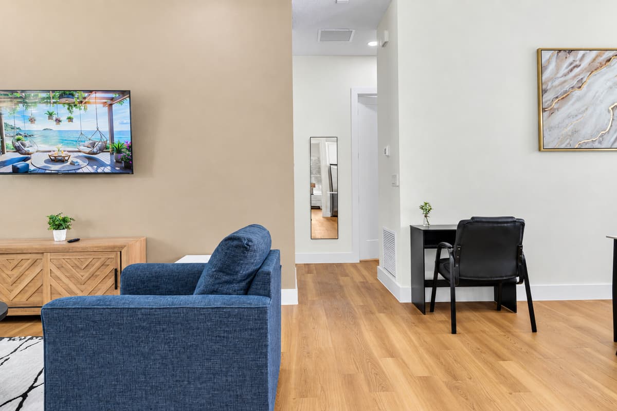 Open-concept living area with comfortable seating, a workspace, and room for everyone to gather.