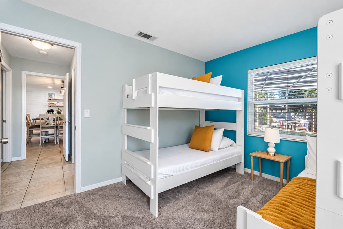 Perfect for kids or groups, this cheerful bunk room offers cozy twin-over-full beds and playful coastal colors.