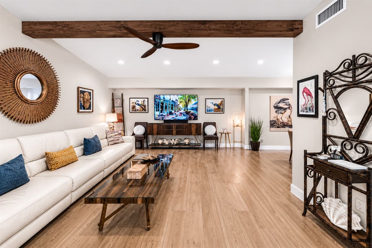 Spacious open living room with oversized sectional seating, vaulted ceilings, and warm modern décor.