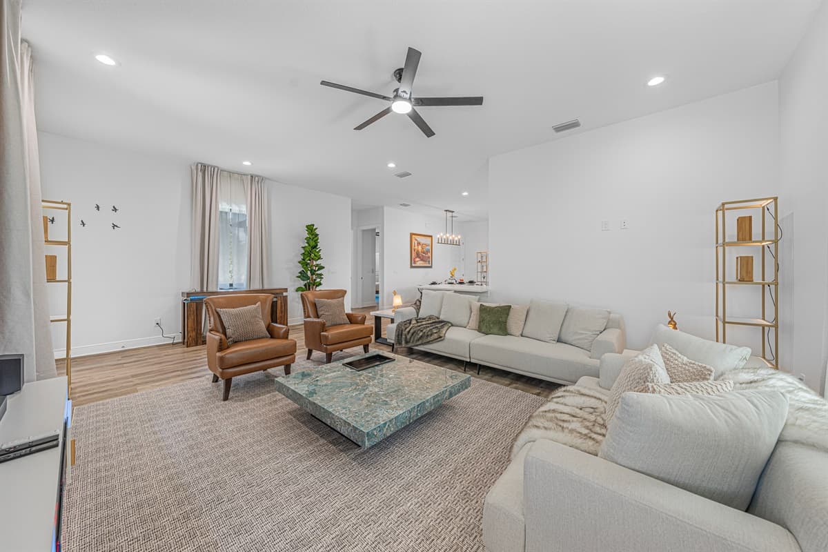 Wide-angle view of the living room highlighting ample seating, contemporary design, and a welcoming atmosphere.