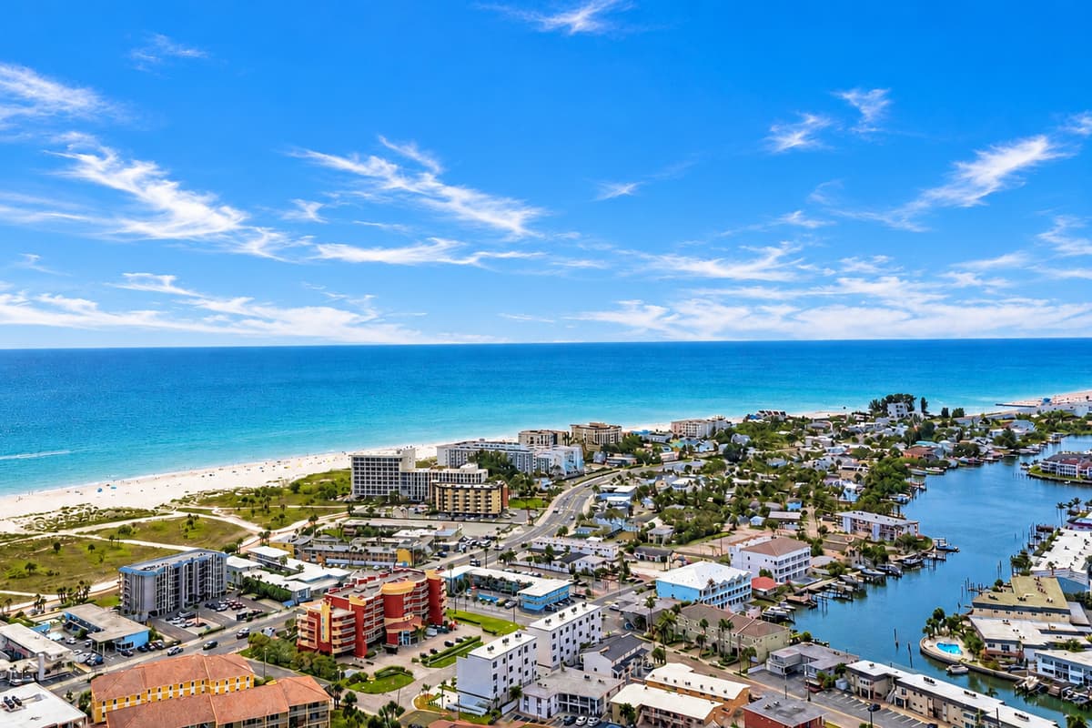Expansive waterfront aerial showcasing the nearby beaches, canals, and tropical scenery.