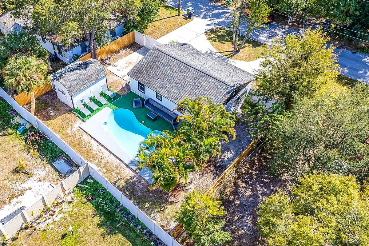 The aerial back side of the property showcasing our immaculate heated pool
