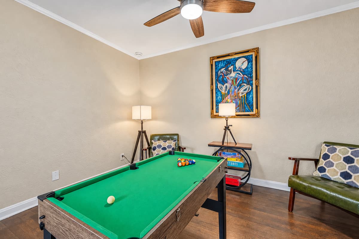 Dedicated game room with pool table and cozy seating for fun, entertainment, and friendly competition.