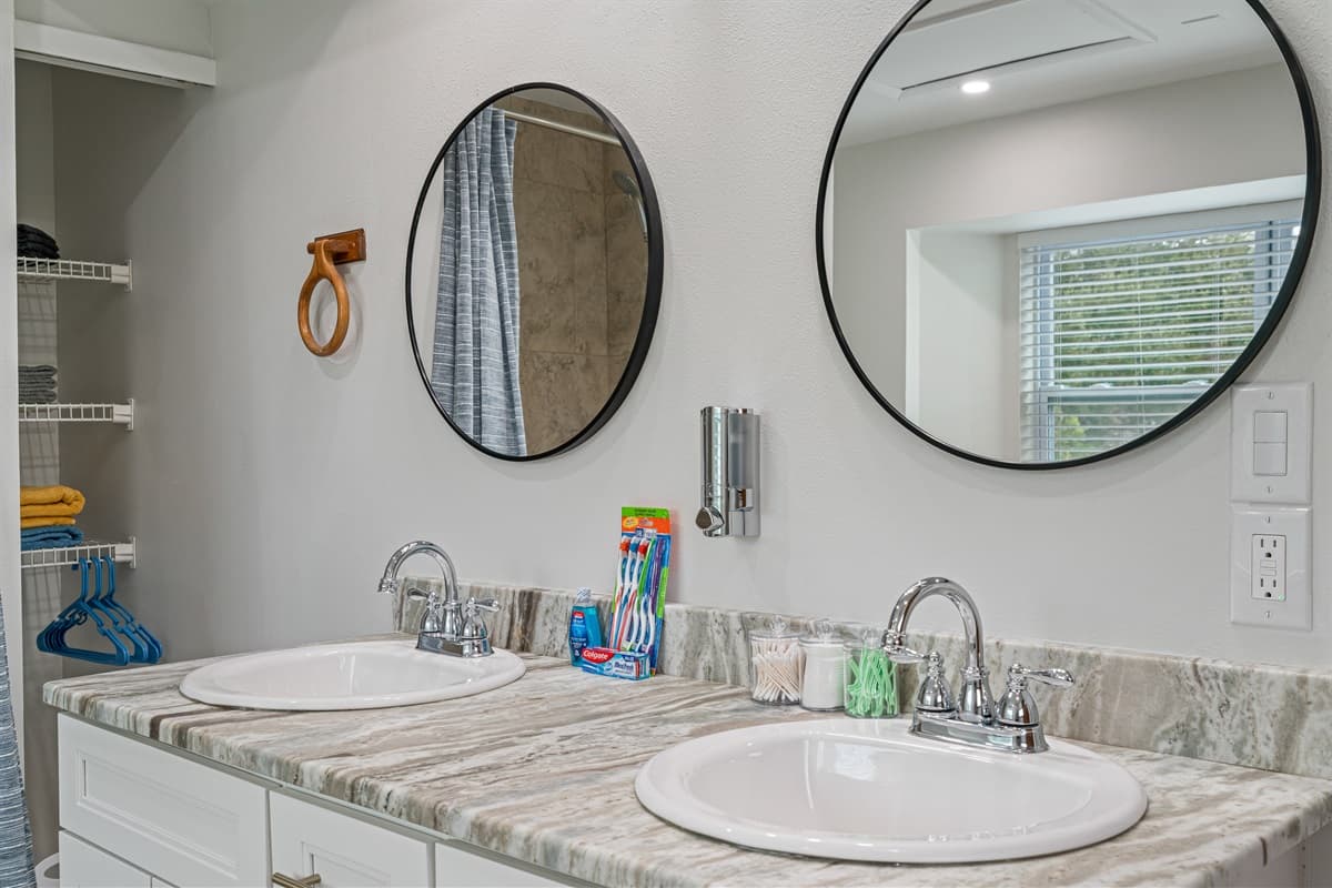 The his and her sinks provide a touch of opulence and convenience. With spacious countertops and ample storage below, you'll have plenty of room to keep your personal items organized and easily accessible.