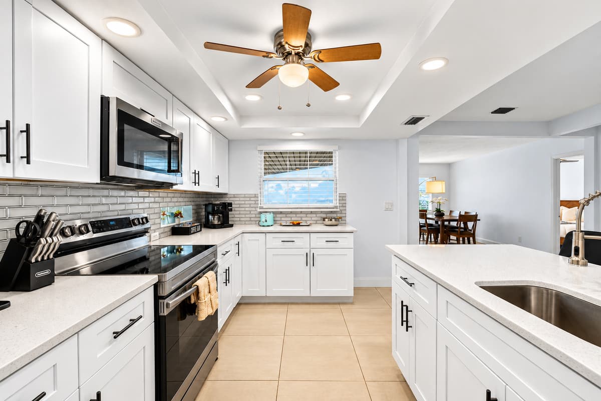 Bright and stylish kitchen with modern appliances, generous counter space, and breakfast seating.