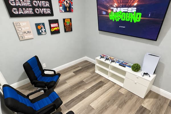 A room built for gamers. Gaming rockers, pop-culture art, and a big Smart TV with a PS5. Kids get their own hangout, adults get the living room back.