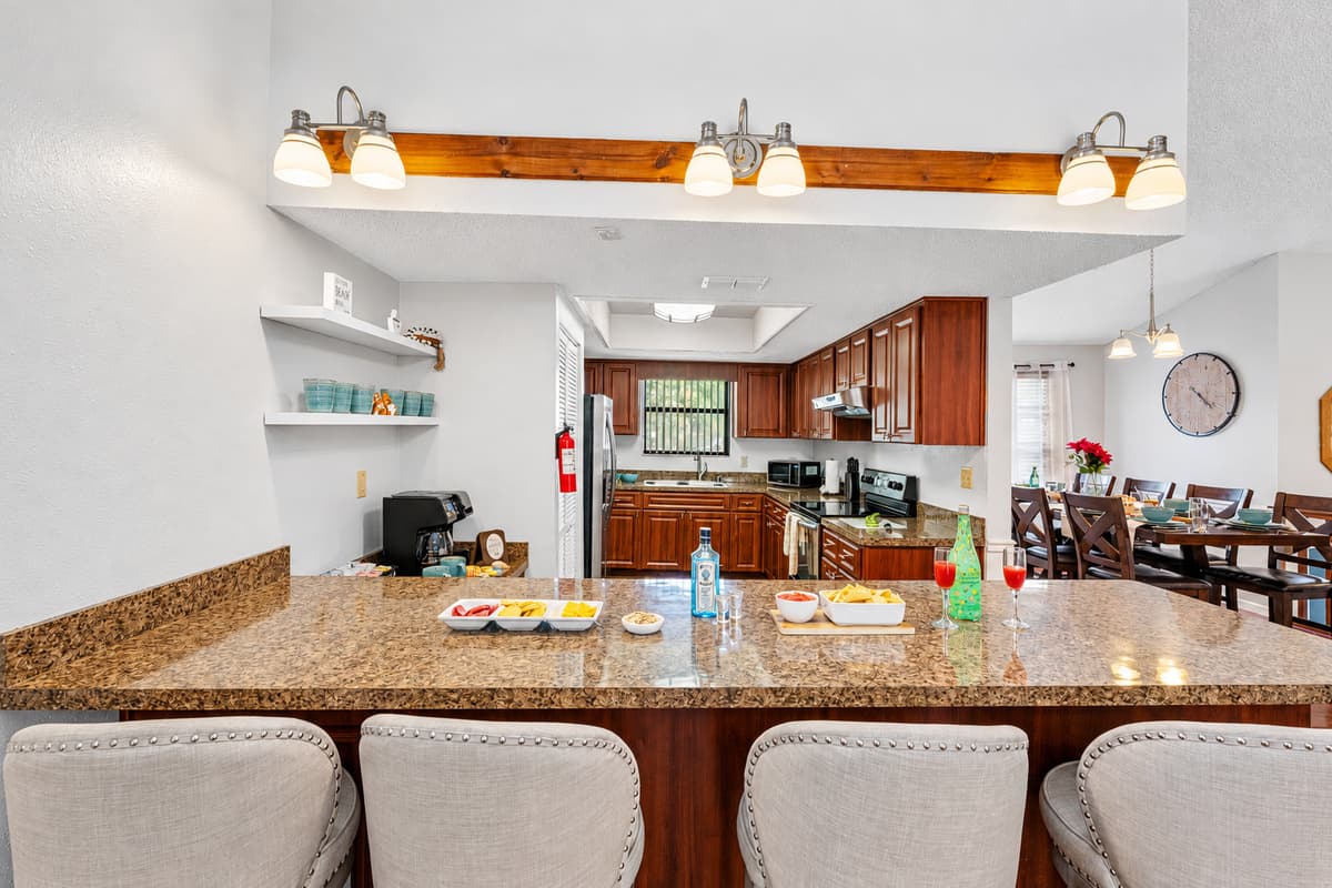The kitchen’s extended countertops offer bar seating, making it a versatile space for everything from casual bites to entertaining guests.
