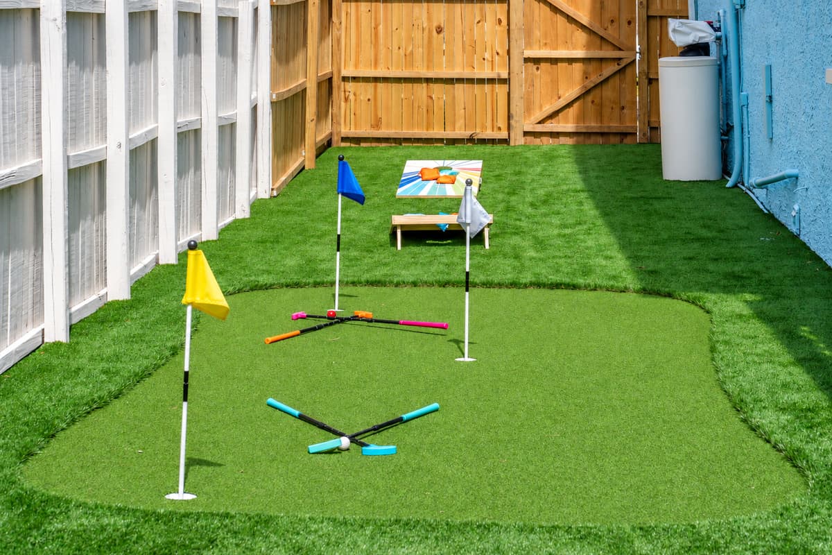This space proves that even side yards can shine—with artificial turf, classic games, and a whole lot of personality.