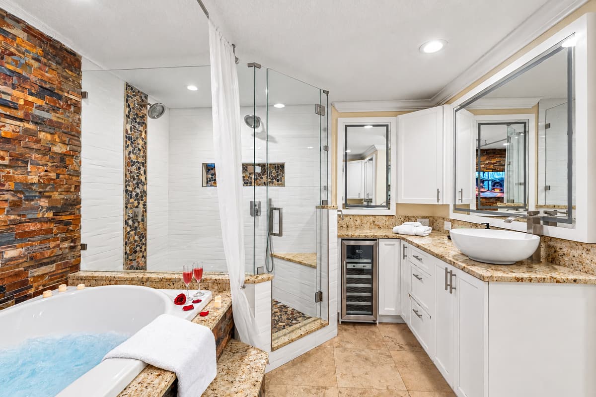 The spacious layout includes his and hers sinks, providing ample counter space and convenience for couples or guests sharing the space.