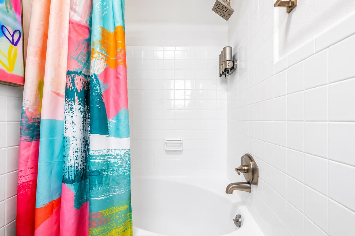 Refresh after a day in the sun with the full bathroom featuring a tub/shower combination, fresh towels, and essential amenities.