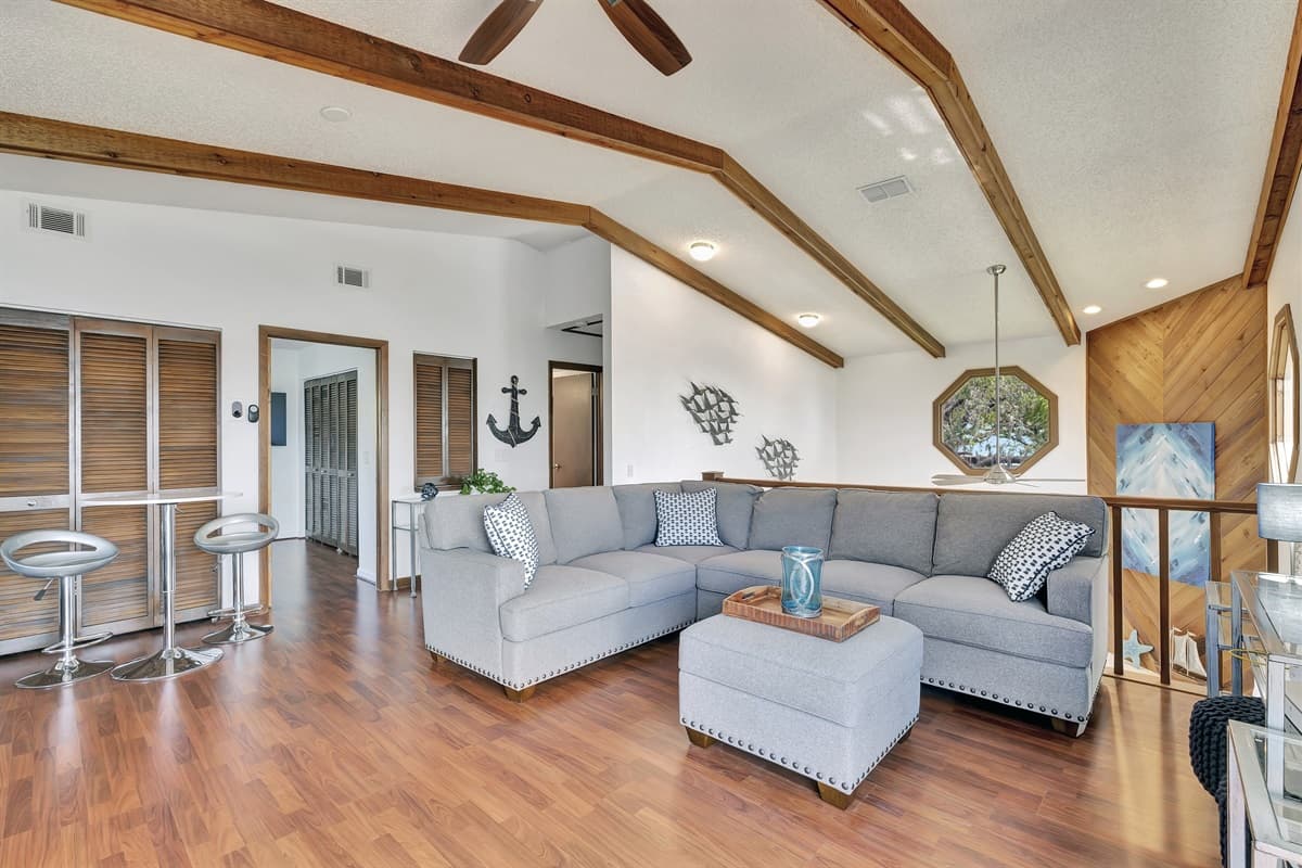 Adjacent to the day bed, a cozy couch awaits, offering ample seating for you and your guests to gather and share moments of laughter and connection.