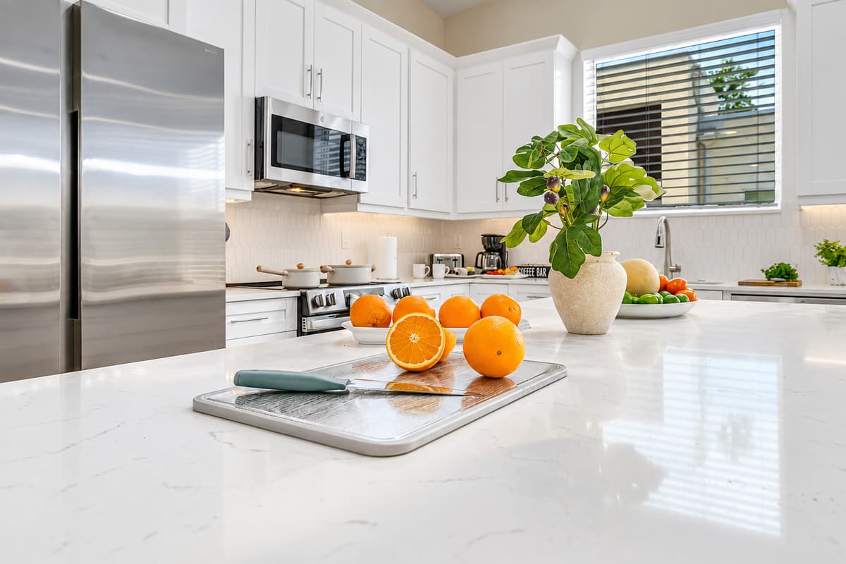 Close-up of kitchen island with fresh accents and ample prep space.