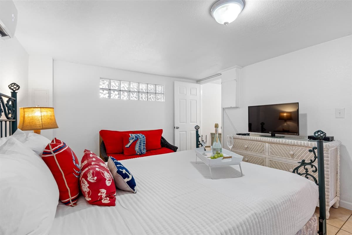 The queen-size bed is dressed in plush, high-quality bedding, including crisp linens and cozy pillows, ensuring that every guest enjoys a restful night’s sleep.