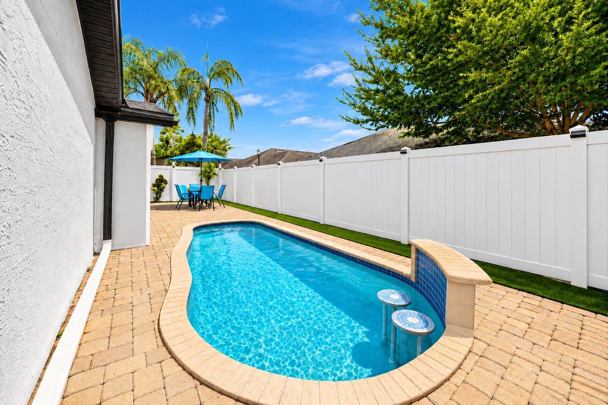 Sparkling private pool with a unique curved design, perfect for cooling off after a day of exploring Tampa's top attractions.