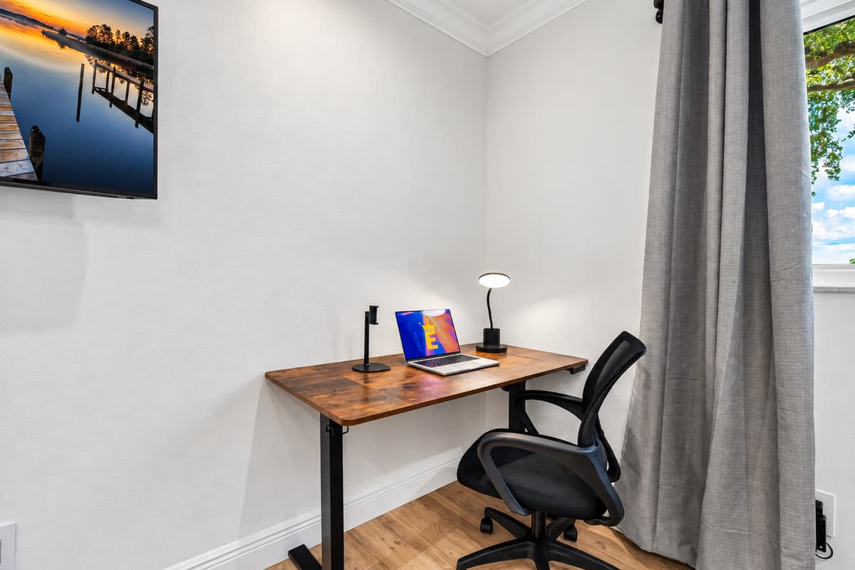 A dedicated workstation with an ergonomic chair makes this room perfect for digital nomads or remote professionals.