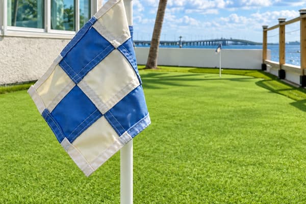 Putting green flag with water views.