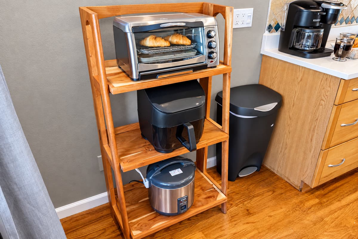 Equipped with a stainless steel oven, microwave, and French-door refrigerator, this kitchen is designed to meet every cooking need.