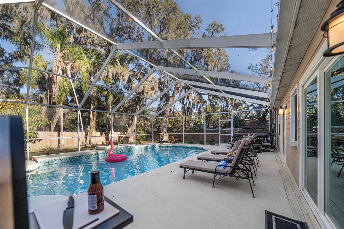 Designed for year-round enjoyment, the screened-in pool area provides privacy, comfort, and relaxation.