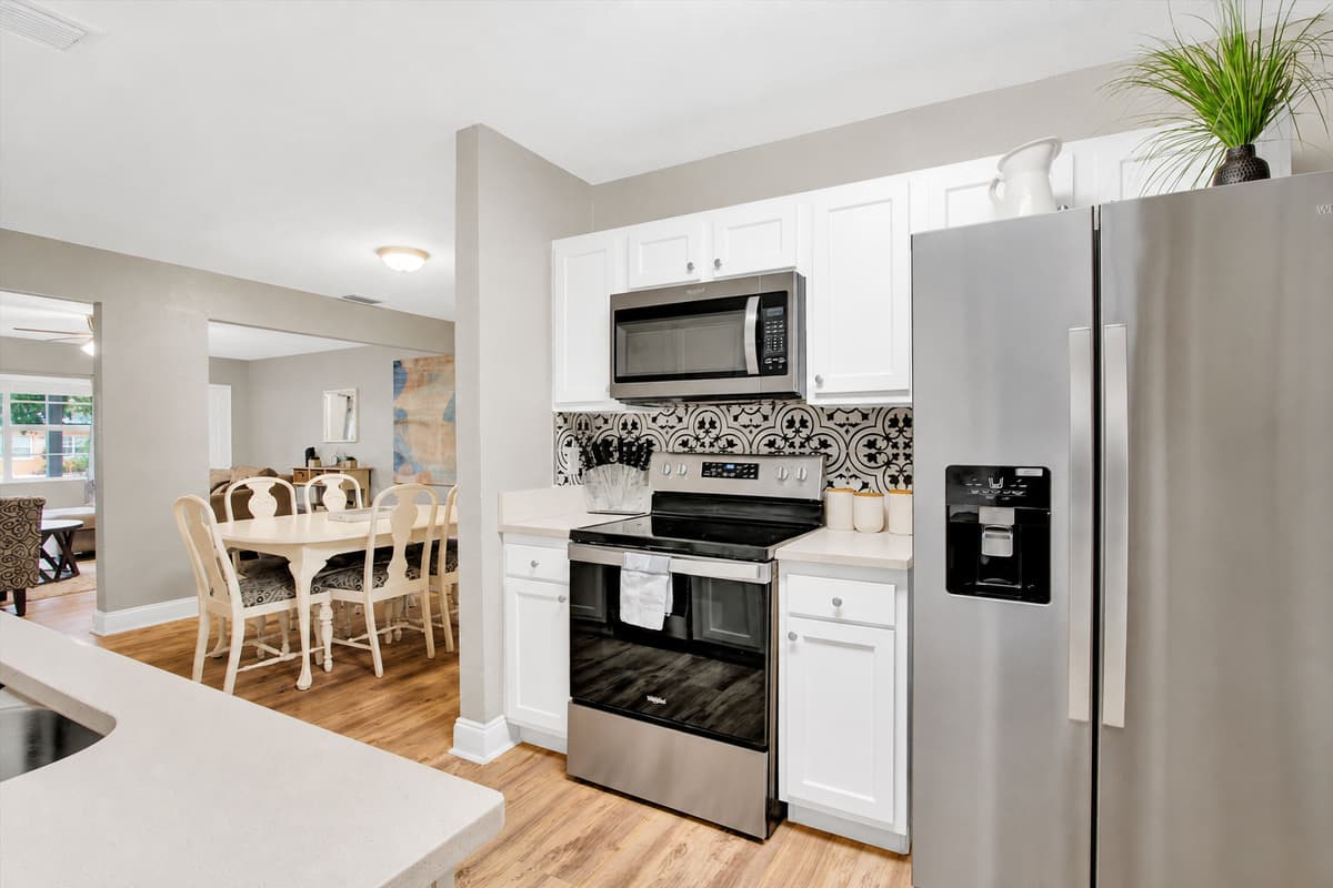 Stainless steel gleams, countertops beckon, and a symphony of modern conveniences awaits your every culinary whim.