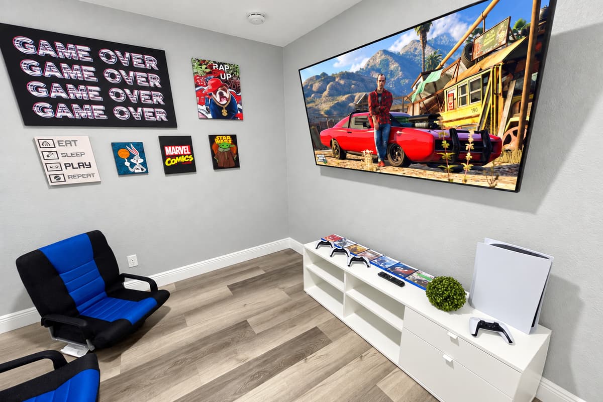 PS5 nights, built right into the house. A dedicated game room with a PlayStation 5, a big Smart TV, gaming chairs, and pop-culture art. Rainy evenings become tournament nights the kids talk about for months.