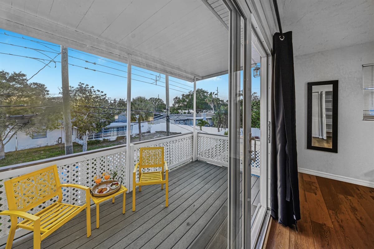 Private balcony with comfortable seating and peaceful neighborhood views—ideal for morning coffee 
Food and drinks shown are for staging purposes only and are not included.