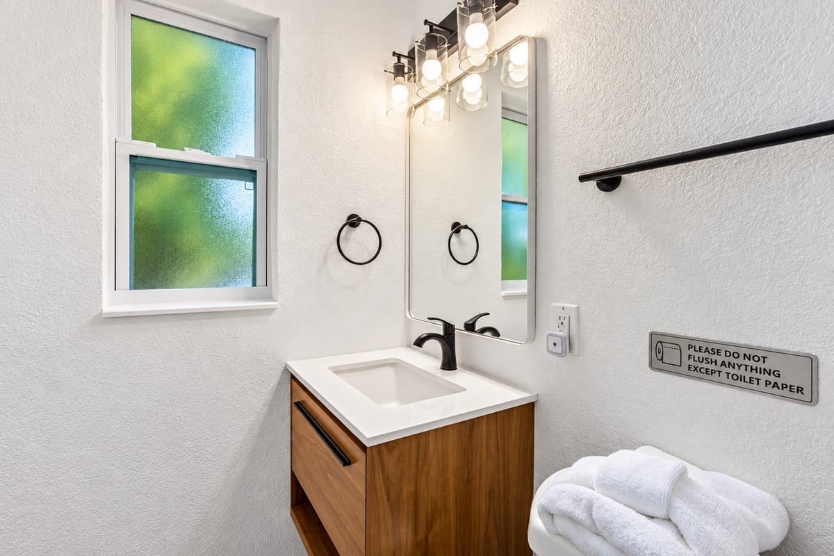 Clean lines and coastal luxury define this space—perfect for relaxing after a beach day or getting glammed up for a night out.