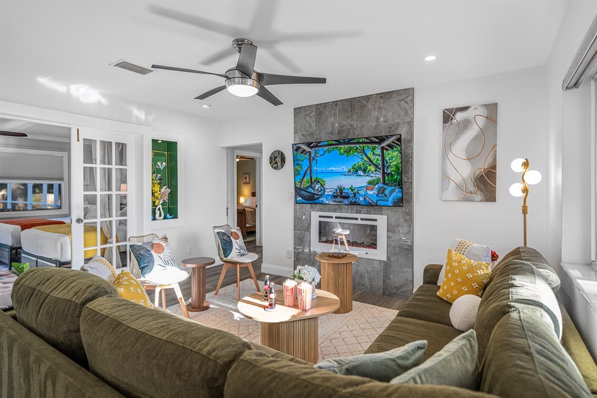 A bright, open living room featuring a plush sectional, stylish accent chairs, and abundant natural light—perfect for relaxing or gathering with loved ones.