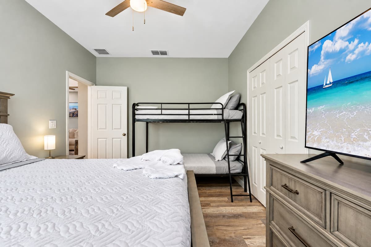The bunk bed adds a touch of whimsy and excitement, perfect for children or adventurous guests seeking a cozy retreat.