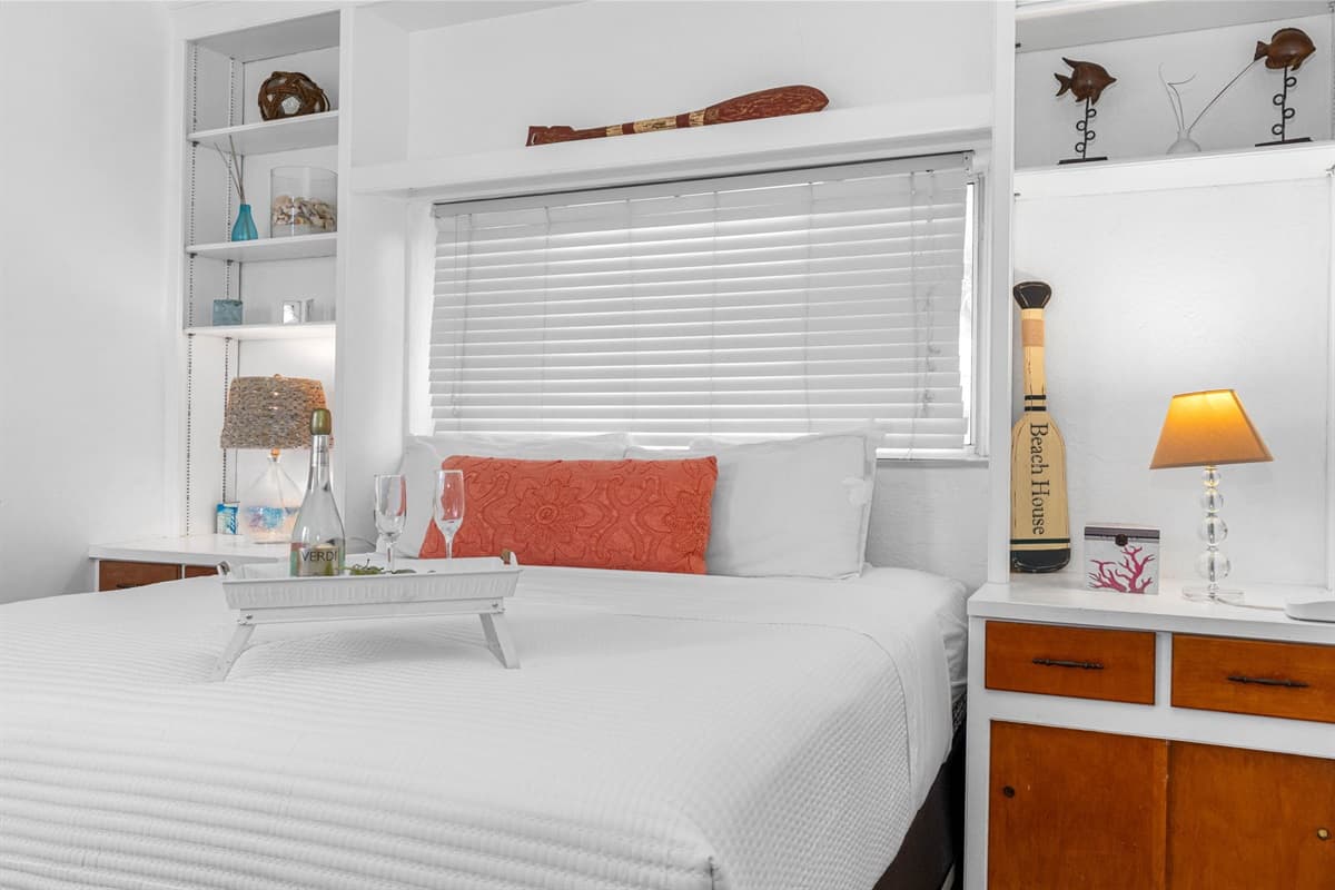 The room features a queen-size bed, perfectly positioned to be the focal point of this serene retreat.