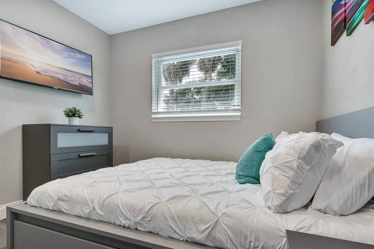 Comfortable bedroom with king sized bed, smart TV and drawers. Sleep safe and sound on the comfort of your home away from home. 