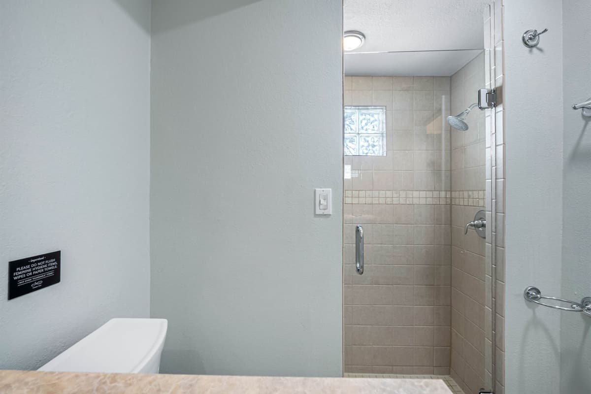 Designed with convenience in mind, featuring dual vanities and a spacious glass shower.
