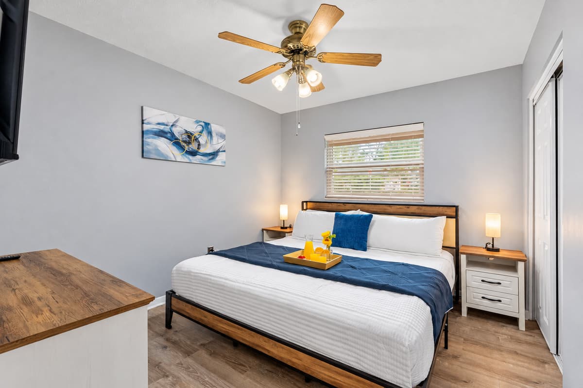 Relax in this cozy king bedroom featuring plush bedding and calming neutral tones.