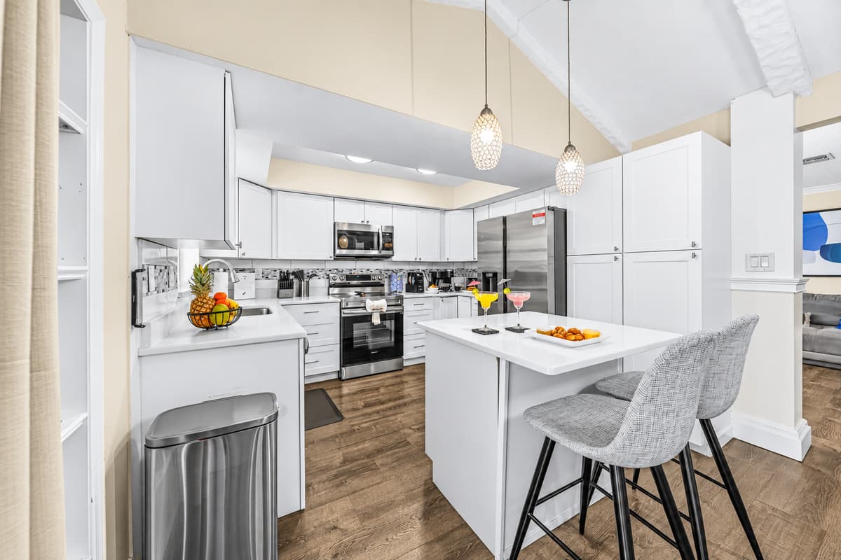 Open-concept kitchen with island seating and plenty of prep space for your group.