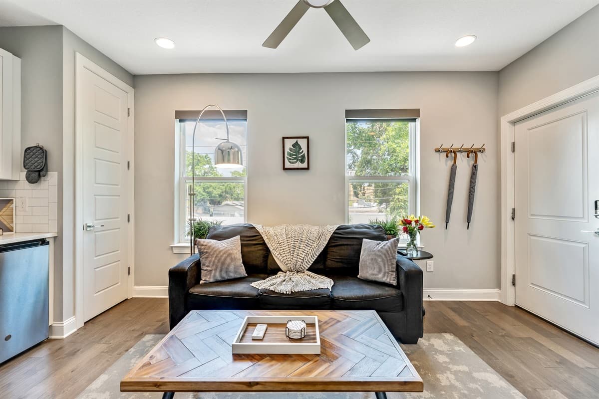 You'll be greeted by the warmth of a comfortable three-seater couch, beckoning you to sink in and make yourself at home.
