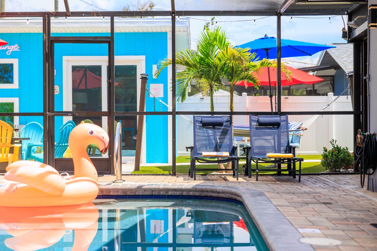 Screened-in pool and outdoor lounge space.