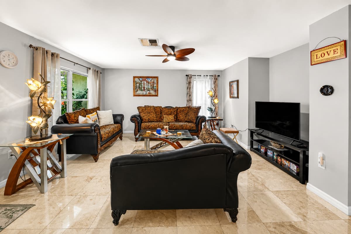 Bright and welcoming common area connecting the living room, dining room, and kitchen.