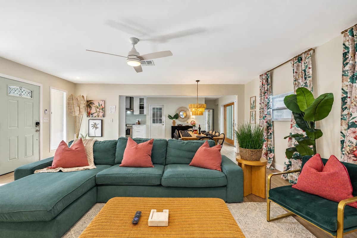 A plush sofa upholstered in soothing shades of sand and coral beckons you to sink into its embrace, offering a perfect spot to unwind after a long day.