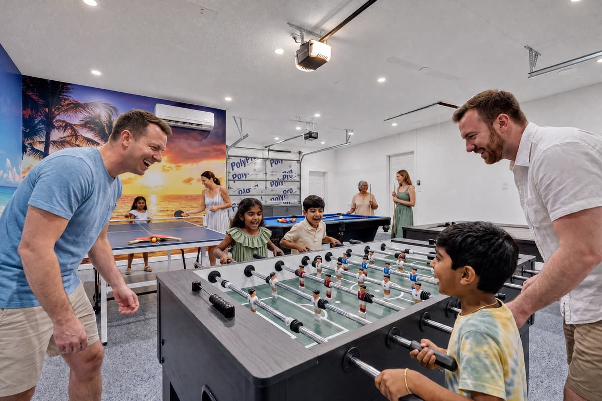 The first game starts before anyone unpacks. Foosball, pool, ping-pong, air hockey and a classic arcade cabinet in one air-conditioned room — so the tournament keeps running when it's 95° outside or raining sideways. Nobody asks what to do next.