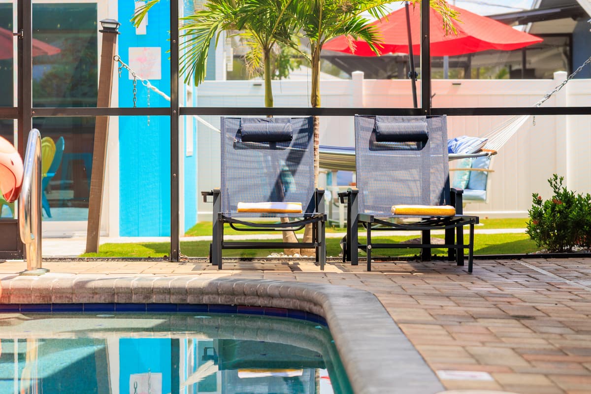 Screened-in pool and outdoor lounge space.