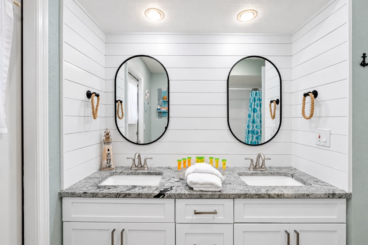 Enjoy the convenience of double vanities, a large walk-in shower, and elegant coastal-inspired details.