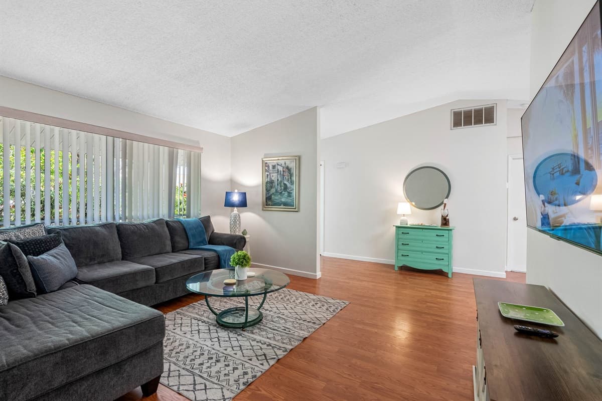​The living room is thoughtfully designed to provide a comfortable and entertaining environment, featuring a state-of-the-art Smart TV and a plush lounging couch.