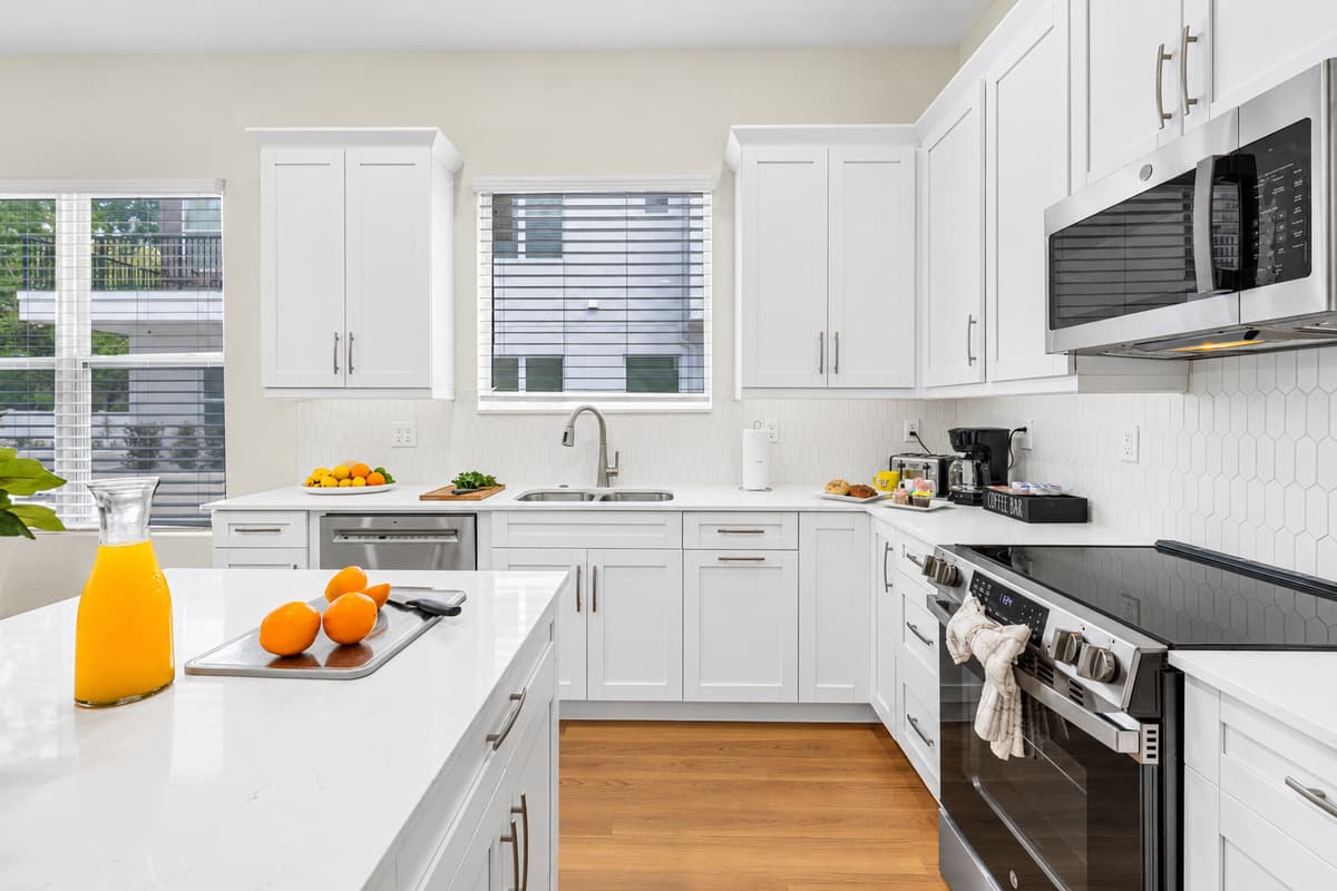 Natural light pours through the kitchen window over a deep sink — washing up is a breeze.