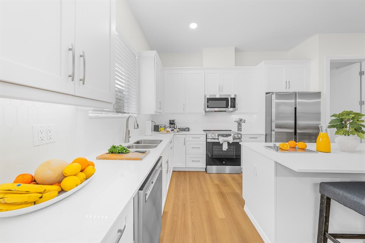 Modern kitchen with sleek cabinetry, stainless steel appliances, and open layout.