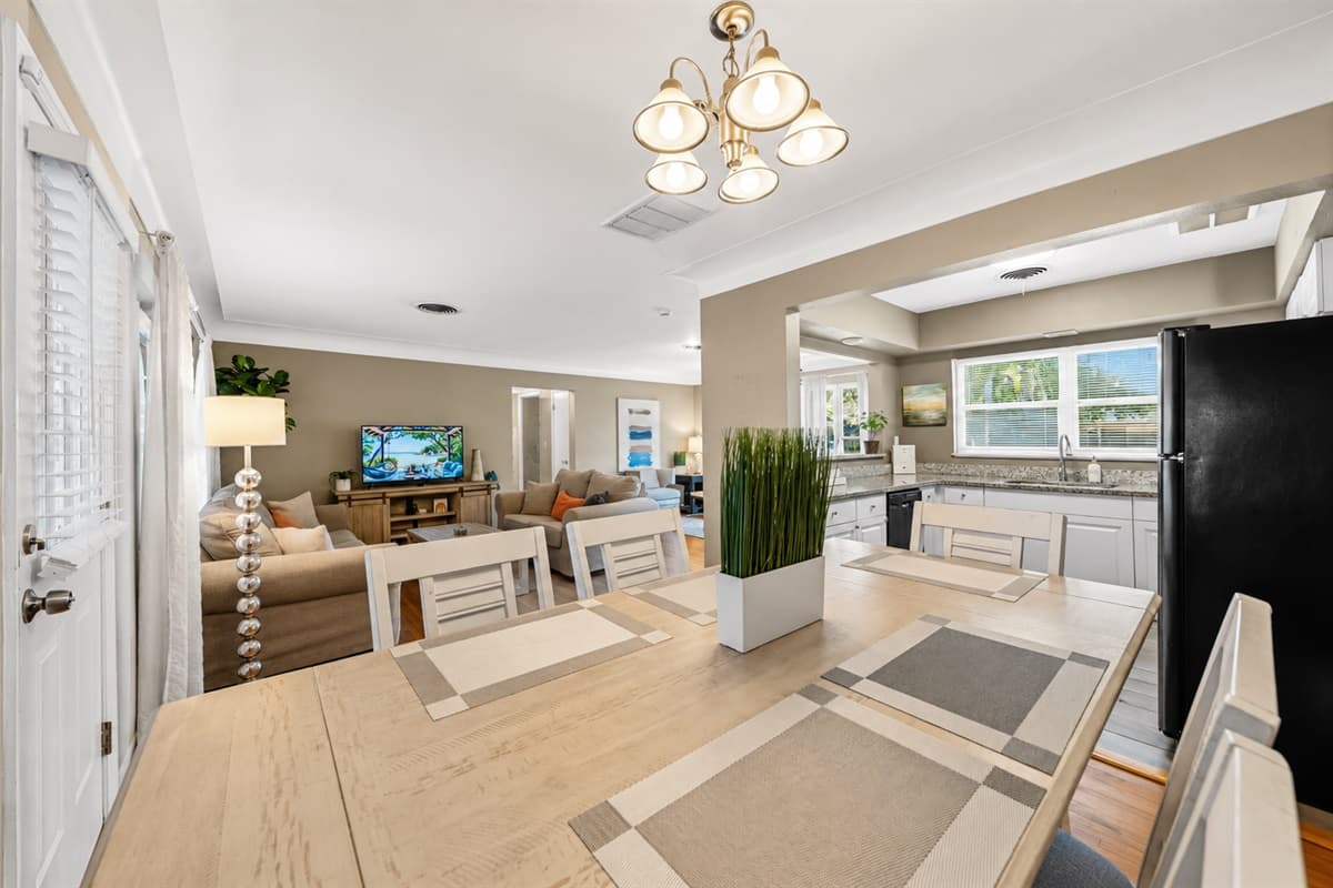 Stylish dining area with seating for the group and an open-concept layout connecting to the kitchen and living room.