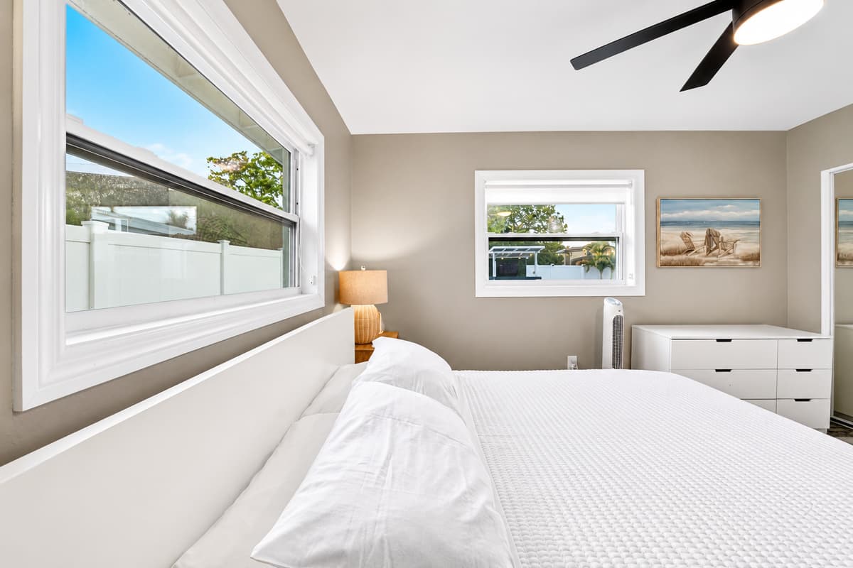 Bedroom perspective highlighting large windows, natural light, and serene views of the outdoor space.