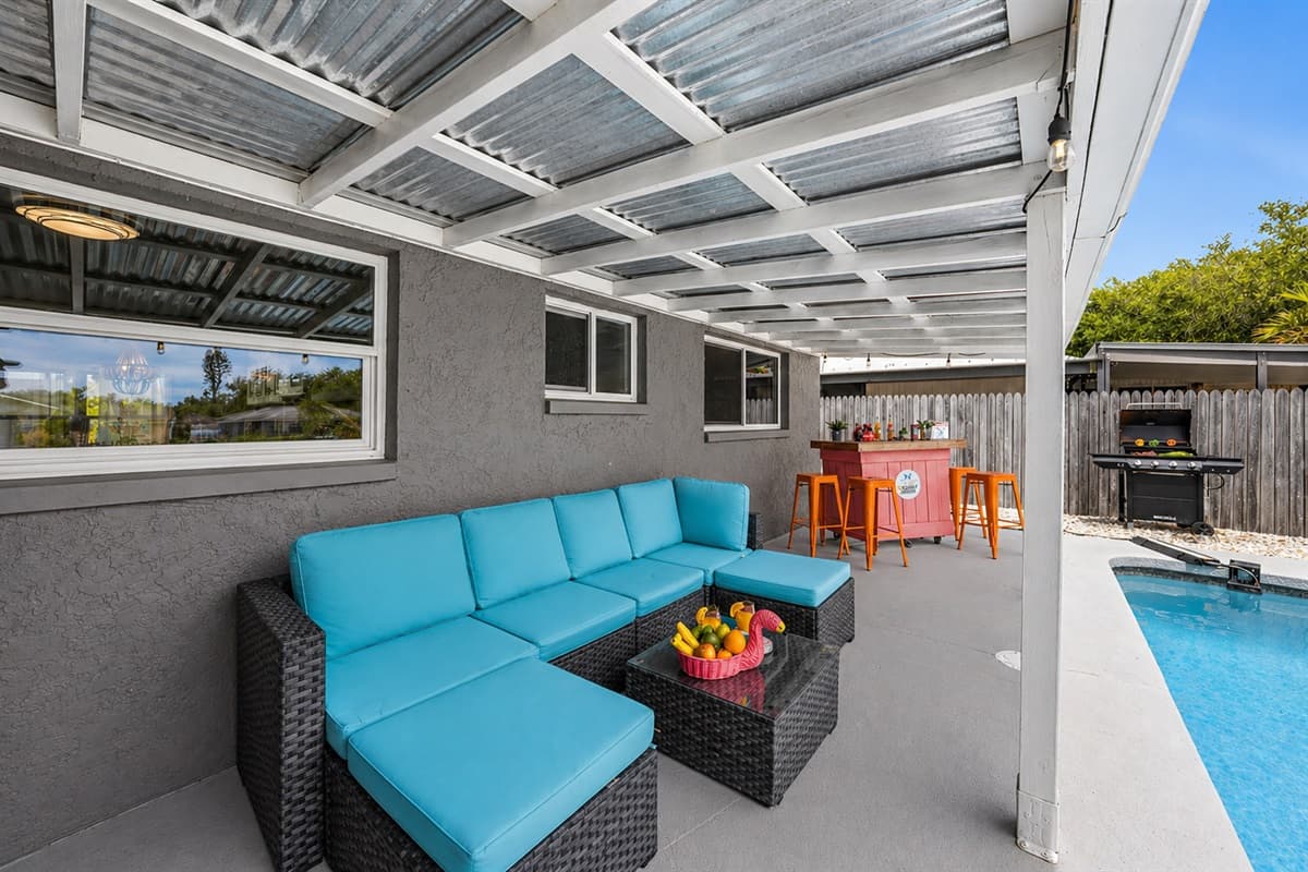 Comfortable outdoor lounge seating under shade, ideal for unwinding by the pool.