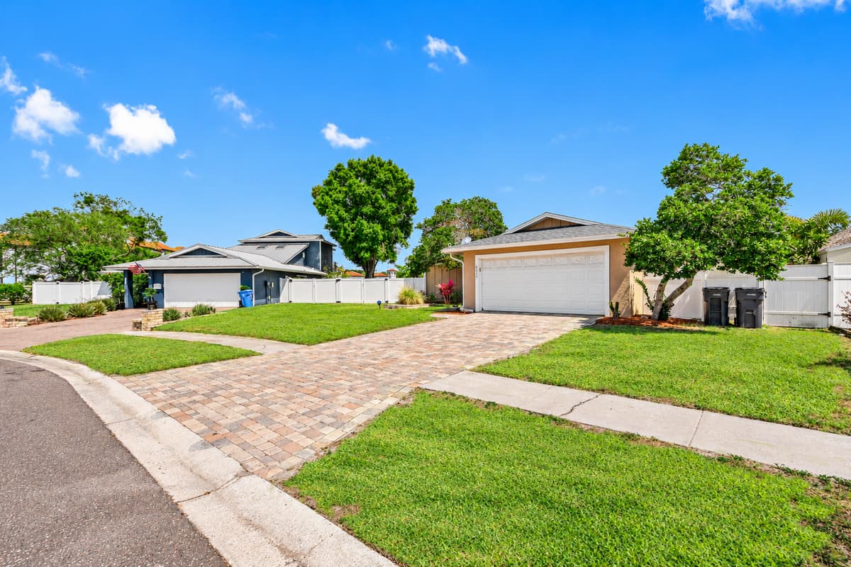 The carefully curated garden beds and manicured lawn accentuate the home's beauty.